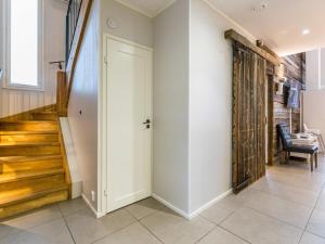 a hallway with a white door and a stairway at Holiday Home Ritari by Interhome in Pälkäne
