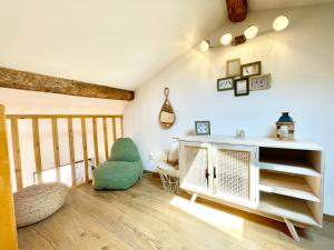 a living room with a white shelf and a chair at Le Mattoni 3 in Menton