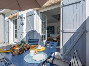 a blue table and chairs on a patio at Holiday Home Bretagne by Interhome in Carnac