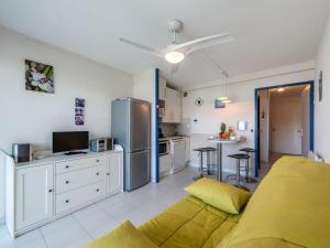 a kitchen and living room with a couch and a refrigerator at Studio Les Deux voiles-3 by Interhome in Cogolin +13 photos