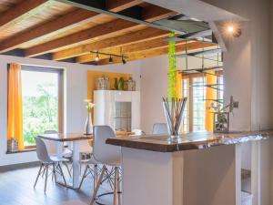 a kitchen with a counter and a table and chairs at Chalet Melograno by Interhome in Sutri