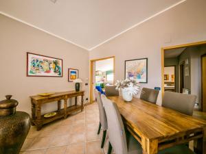 a dining room with a wooden table and chairs at Apartment Bouganville di Patrizia by Interhome in Castellammare del Golfo