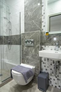 a bathroom with a toilet and a sink and a shower at Villa Morfeas in Paralia Katerinis +36 photos
