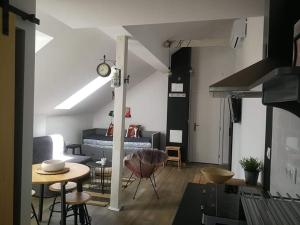 a living room with a table and a bed at Studio apartman HANA in Drežnik Grad
