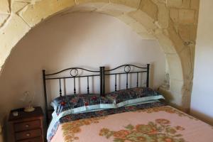 A bed or beds in a room at Masseria Cricelli
