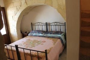 A bed or beds in a room at Masseria Cricelli