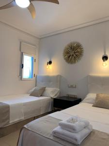 A bed or beds in a room at Playa de Levante Sea View Apartment
