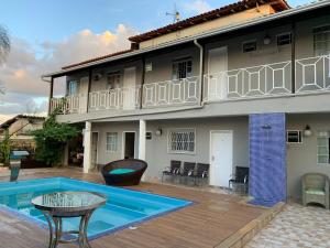 a house with a swimming pool in front of it at Hospedagem em Diamantina in Diamantina