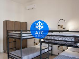 A bed or beds in a room at Lobby Collective Hostel - Lecce