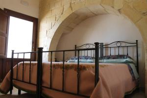 A bed or beds in a room at Masseria Cricelli