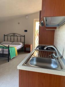 A bed or beds in a room at Appartamenti Vacanze Minervino Még 37 kép