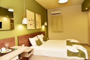 a bedroom with a bed and a desk and a bed sidx sidx sidx at Lafo Rooms in Elafonisi