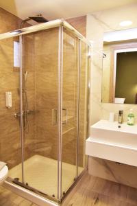 a shower with a glass door next to a sink at Lafo Rooms in Elafonisi