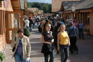 a crowd of people walking down a street at Quiet, cosy annexe room in Rough Close