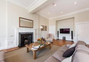 a living room with a couch and a fireplace at The New Town Idyll @ Dublin Street in Edinburgh