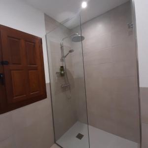 a bathroom with a shower with a glass door at Casa Fénix in Altea
