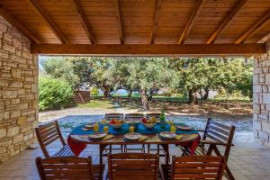 a table with bowls of food on a patio at Villa Dimitris Beach in Kassiopi