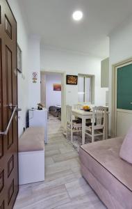 a room with a bed and a dining room with a table at Downtown Apartment in Berat