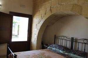 A bed or beds in a room at Masseria Cricelli