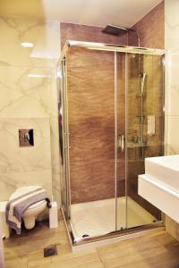 a shower with a glass door in a bathroom at Lafo Rooms in Elafonisi