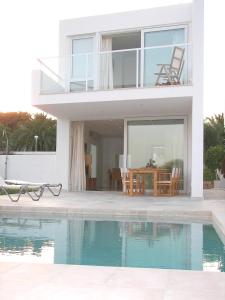 a villa with a swimming pool and a house at Villa Mar in Cala en Blanes