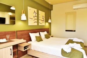 a small bedroom with a bed and a desk at Lafo Rooms in Elafonisi