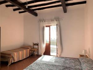 Postel nebo postele na pokoji v ubytování Casa Vittoria - panoramica in centro a Leni, Isola di Salina