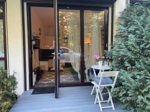 a patio with two chairs and a table on a porch at RESET ul. Ratibora 66 in Jurata +20 photos