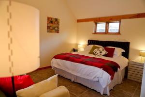 a bedroom with a large bed and a chair at The Grove Cromer in Cromer
