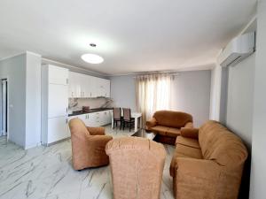 a living room with two couches and a kitchen at Sky - Apartment - Brown in Vlorë