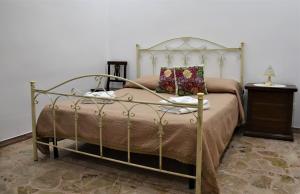 a bedroom with a bed with a metal frame at La Rosa Antica in Avetrana