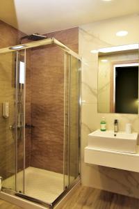a bathroom with a shower and a sink at Lafo Rooms in Elafonisi