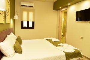 a bedroom with a bed with two towels on it at Lafo Rooms in Elafonisi