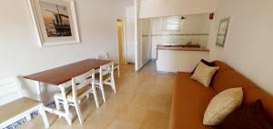 a living room with a table and a couch at Granada Apartments Familiar Deluxe in Portinatx