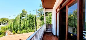 a balcony of a house with a chair on it at Granada Apartments Familiar Deluxe in Portinatx