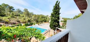a view of the pool from the balcony of a house at Granada Apartments Familiar Deluxe in Portinatx