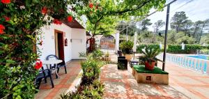 a patio with a table and chairs and a pool at Granada Apartments Familiar Deluxe in Portinatx