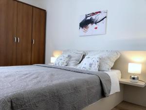 Posteľ alebo postele v izbe v ubytovaní Villy City Apartment