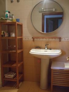 a bathroom with a sink and a mirror at Apartamento Faro de Tapia in Tapia de Casariego +9 photos
