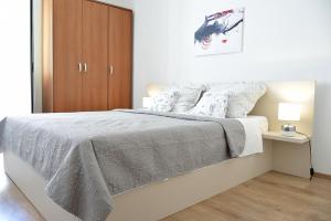 Posteľ alebo postele v izbe v ubytovaní Villy City Apartment