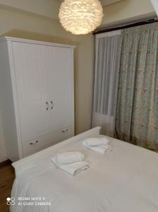 a bedroom with a bed with two towels on it at Νόνη in Mileai