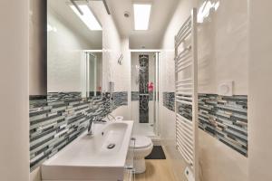 ein Badezimmer mit einem weißen Waschbecken und einem WC in der Unterkunft Studio Le Rosier - Paris Gare du Nord en 15 min - in Deuil-la-Barre