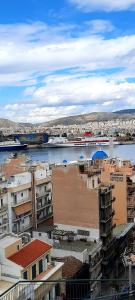 a view of a city with a river and buildings at LUXURY APARTMENT Port of Piraeus in Piraeus