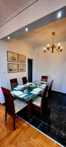 a dining room with a glass table and chairs at LUXURY APARTMENT Port of Piraeus in Piraeus