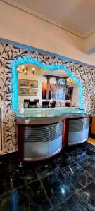 a bar with a blue light on a wall at LUXURY APARTMENT Port of Piraeus in Piraeus +26 photos