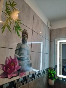 a mural of a buddha on the wall of a bathroom at CHARMANT T2 VUE MARINA PLAGES A PIED in Sète