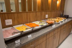 a buffet line with many different types of food at Ilha Porchat Hotel in São Vicente +123 photos