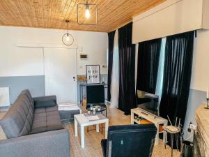 a living room with a couch and a tv at Milea Mansion in Limassol +21 photos