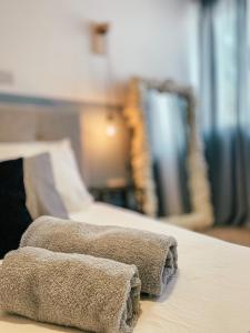 a pile of towels sitting on top of a bed at Milea Mansion in Limassol