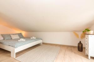 a bedroom with a bed in a attic at Apartment Egon in Malinska